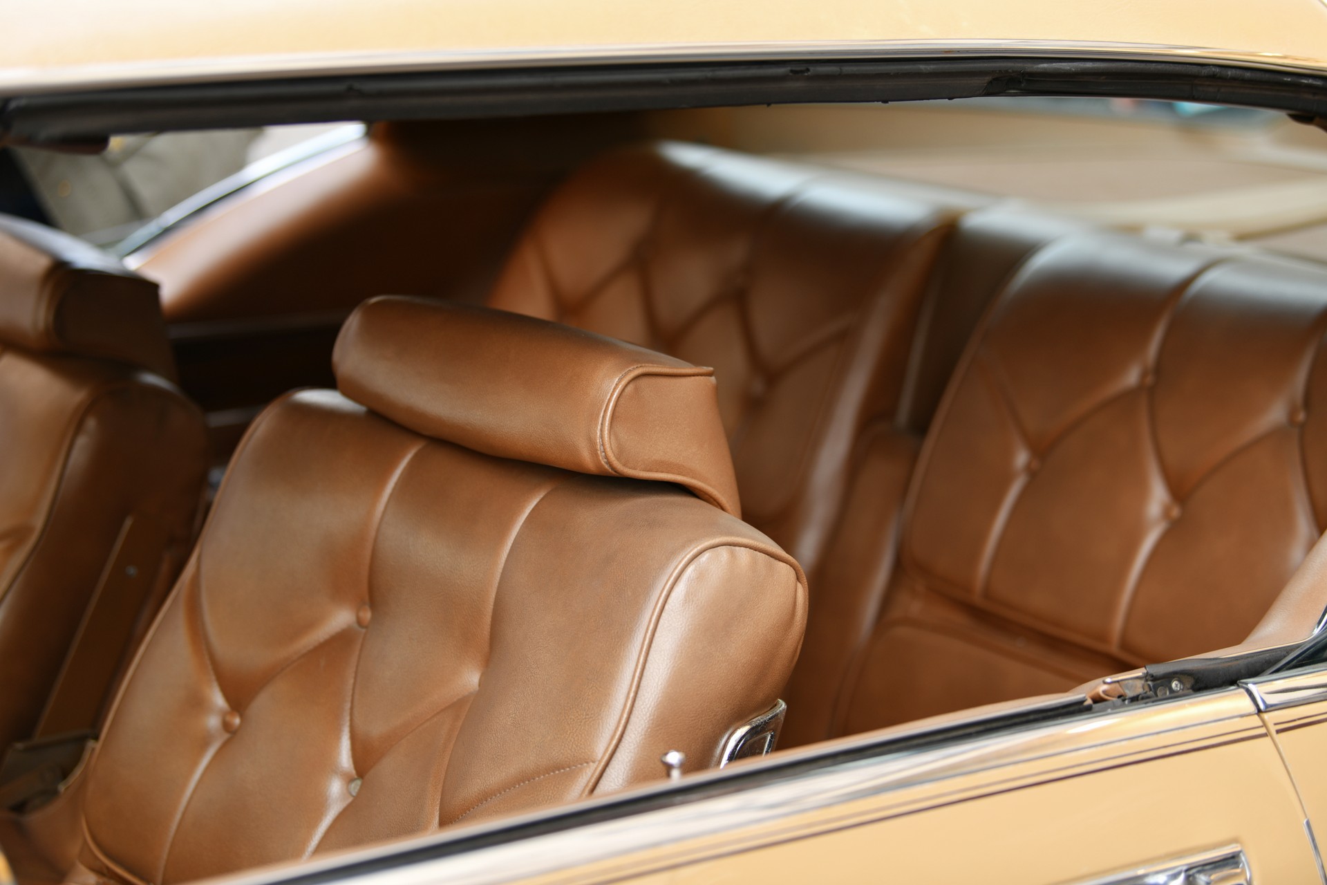 A brown vintage armchair in a car interior